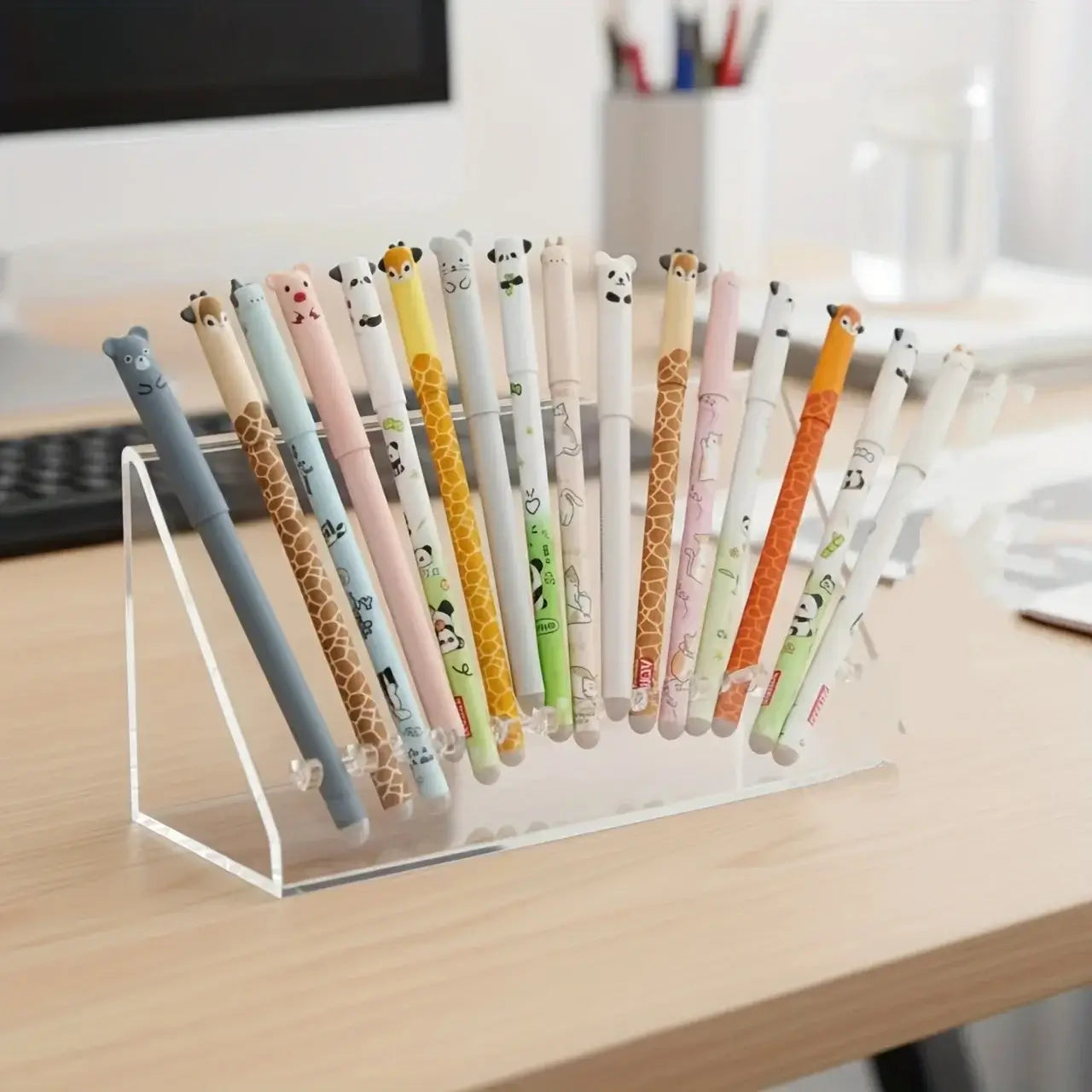 Collection of colorful gel pens with animal-themed prints displayed in a clear pen holder on a desk, perfect for creative projects and writing