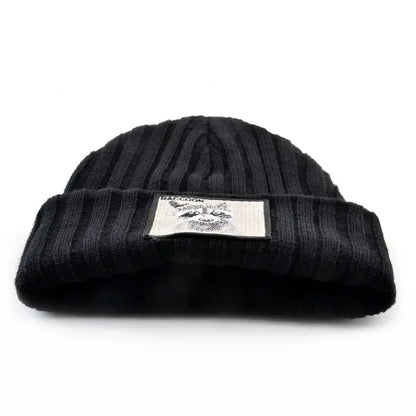 Close-up of black ribbed knit beanie with embroidered raccoon patch, warm unisex winter accessory for cold days