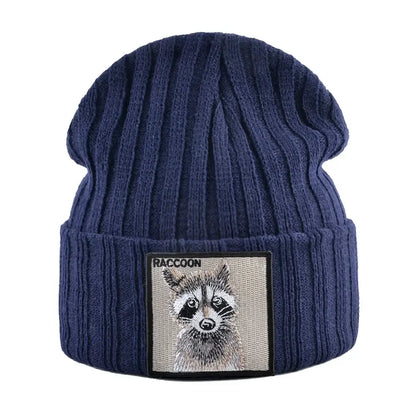 Beige ribbed knit beanie with raccoon patch, measuring 23cm height and 22cm width, featuring a raccoon illustration patch, perfect for winter.