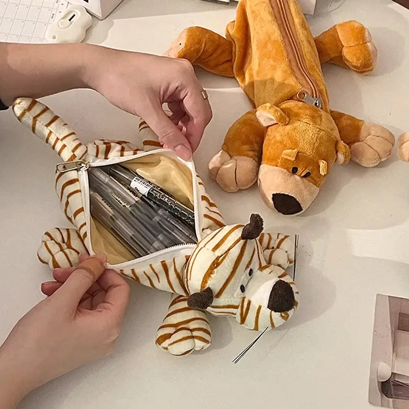 Close-up of plush tiger pencil case with zipper, filled with pens, soft fabric, striped pattern, ideal for children’s school accessories