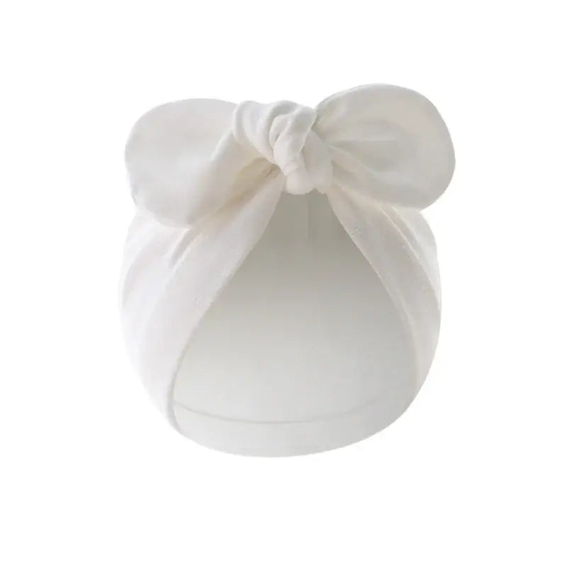 Baby turban hat with bow in pink cotton, adorable and soft for girls, suitable for daily use and special occasions.