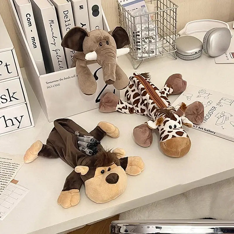 Collection of plush animal pencil cases including elephant, giraffe, lion, and zebra, soft fabric, various animal designs for kids