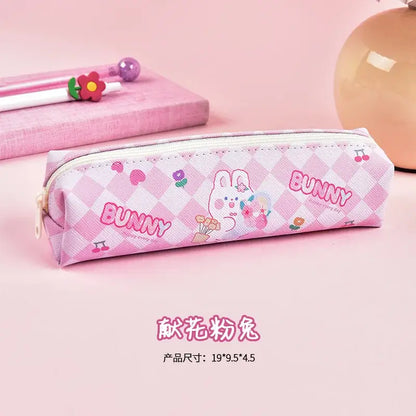 Pink checkered pencil case with cute bunny character holding a flower, decorated with hearts and floral motifs, perfect for school use.