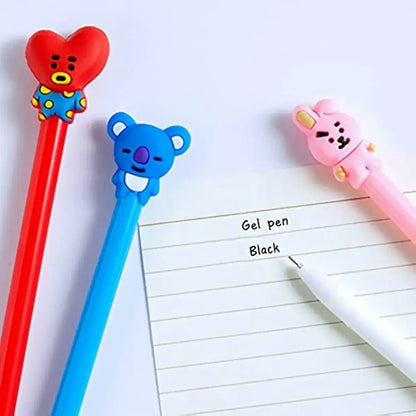 Pink sheet of paper with handwritten notes and colorful gel pens featuring animal-shaped toppers for creative writing